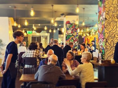 people sat at tables in a bar